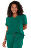 A green short-sleeve top with a v-neck and a pocket, worn by a smiling woman with curly hair.