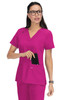 A pink medical top with short sleeves and a pocket, featuring a logo, worn by a woman with glasses.