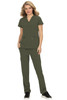 A woman wearing an olive green scrub set with a v-neck top and pants, featuring pockets. The outfit includes a logo.