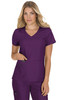 A woman wearing a purple top with a v-neck and pockets, showcasing a stylish design. The top has a logo.