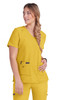 A woman wears a vibrant yellow scrub top with a v-neck and pockets, featuring a logo.
