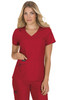 A woman wearing a red scrub top with a v-neck and two pockets, featuring a logo on one pocket.