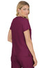 A woman models a burgundy top with short sleeves, showing a back view. The top features a logo and a relaxed fit.