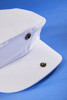 A white Cabrio Cap featuring bronze buttons on a blue background.