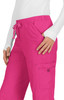 A pair of bright pink pants with a drawstring waist and side pockets, featuring a logo on the pocket.