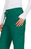 Green pants with an elastic waistband and a side pocket, worn by a person in a white long-sleeve top.