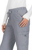 A pair of grey pants featuring a drawstring waist and a side pocket, modelled by a person.