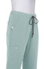 Light green pants with an elastic waistband, side pockets, and a drawstring detail. The product includes a logo.