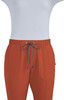 A pair of rust-coloured jogger pants with an elastic waistband and two front pockets, featuring a drawstring.