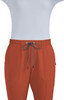 A pair of rust-coloured jogger pants with an elastic waistband and drawstring, featuring pockets and a logo.