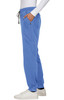 A pair of blue jogger pants with pockets and an elastic waistband, styled with a white long-sleeved top.