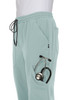 A pair of light mint jogger pants featuring side pockets, one holding a stethoscope, and a drawstring waist.