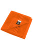 An orange hand towel with a folded design and a tag, featuring stripes along the edge.