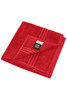 A red hand towel folded neatly, featuring two striped patterns and a label.