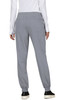 A pair of grey jogger pants featuring an elastic waistband and back pockets, with a person wearing them from the back.
