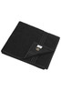 A black bath towel featuring a textured pattern and a label. It is neatly folded.