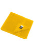 A yellow bath towel with a textured finish and a folded corner, featuring a brand logo.