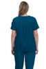 A women's scrub top in teal, featuring a relaxed fit and back pleat design. It has a brand logo on one sleeve.