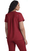 A red scrubs top featuring a back pleat design, short sleeves, and a logo.