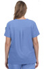 A blue medical scrub top featuring a pleat detail at the back, worn by a female model. It has a logo on the sleeve.