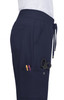 Navy Atria Pant featuring pockets with pens and scissors, designed for functionality and comfort.