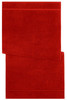 A red bath towel featuring a textured design, neatly folded with a branded logo in one corner.