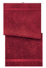 A red bath towel, featuring a textured design and decorative stripes, displayed folded. It has a subtle logo.