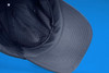 A black six-panel Coolmax® cap featuring a breathable mesh lining. It has a curved brim and an inner sweatband.