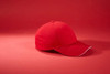 A red 6 panel brushed sandwich cap with a contrasting trim, featuring a logo on the front.