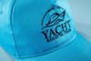 A light blue 5 panel cap made of organic cotton featuring a logo embroidered on the front.