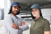 A navy blue six-panel cap with a neck guard, worn by a man and a woman in casual attire.