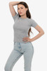 A fitted grey baby rib tee worn by a model, styled with light blue jeans and a casual pose.