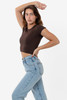 A brown cap sleeve crop top paired with light blue high-waisted jeans, model posing against a plain background.