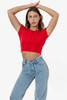 A model poses in a red cap sleeve crop top paired with light blue jeans. The top features a fitted design and has a logo.