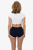 Interlock running shorts in navy blue with a white trim, featuring a model wearing a white crop top.