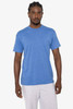 A man wearing a blue short sleeve cotton poly crew tee, standing against a plain background. The shirt has a logo.
