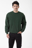 A green heavy fleece pullover sweater worn by a male model, featuring long sleeves and a relaxed fit.