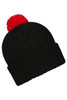 A black knitted beanie featuring a bright red pompon on top, with a ribbed design and a fold-over cuff.