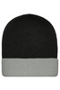 A knitted beanie in black with a grey cuff. The beanie features a logo or branding.