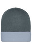 A knitted beanie in dark grey with a light grey cuff, featuring a logo on the side.