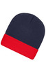 A knitted beanie in navy blue with a red folded cuff. The beanie features a logo on the side.