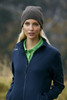 A woman wearing a grey cotton beanie and a navy jacket, standing outdoors with a blurred natural background.