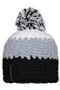 A knitted beanie featuring a pompon, in shades of grey, white, and black, with a logo tag.