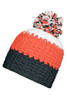 A knitted beanie in orange, white, and navy blue featuring a fluffy pompon on top and a logo tag.