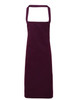 A deep burgundy organic cotton bib apron with adjustable neck straps and no visible logos.