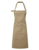 A heavy cotton canvas apron in a khaki colour, featuring multiple pockets and an adjustable strap.