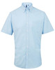 A short-sleeve button-up shirt in light blue with a pocket and a logo on the collar.