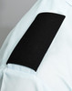 A light blue shirt with a black fabric epaulette on the sleeve, featuring a solid black section.