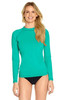 A long sleeve rashie in vibrant teal with a fitted design, featuring a logo on the chest area.