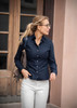 A navy button-up shirt for women features a classic collar and a tailored fit, paired with light-coloured trousers.